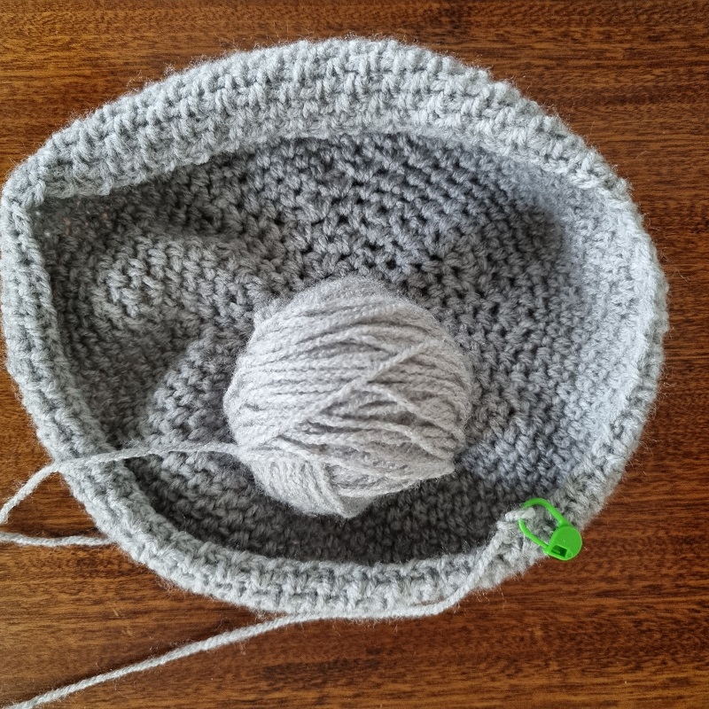 green stitch holder holding the end of a row